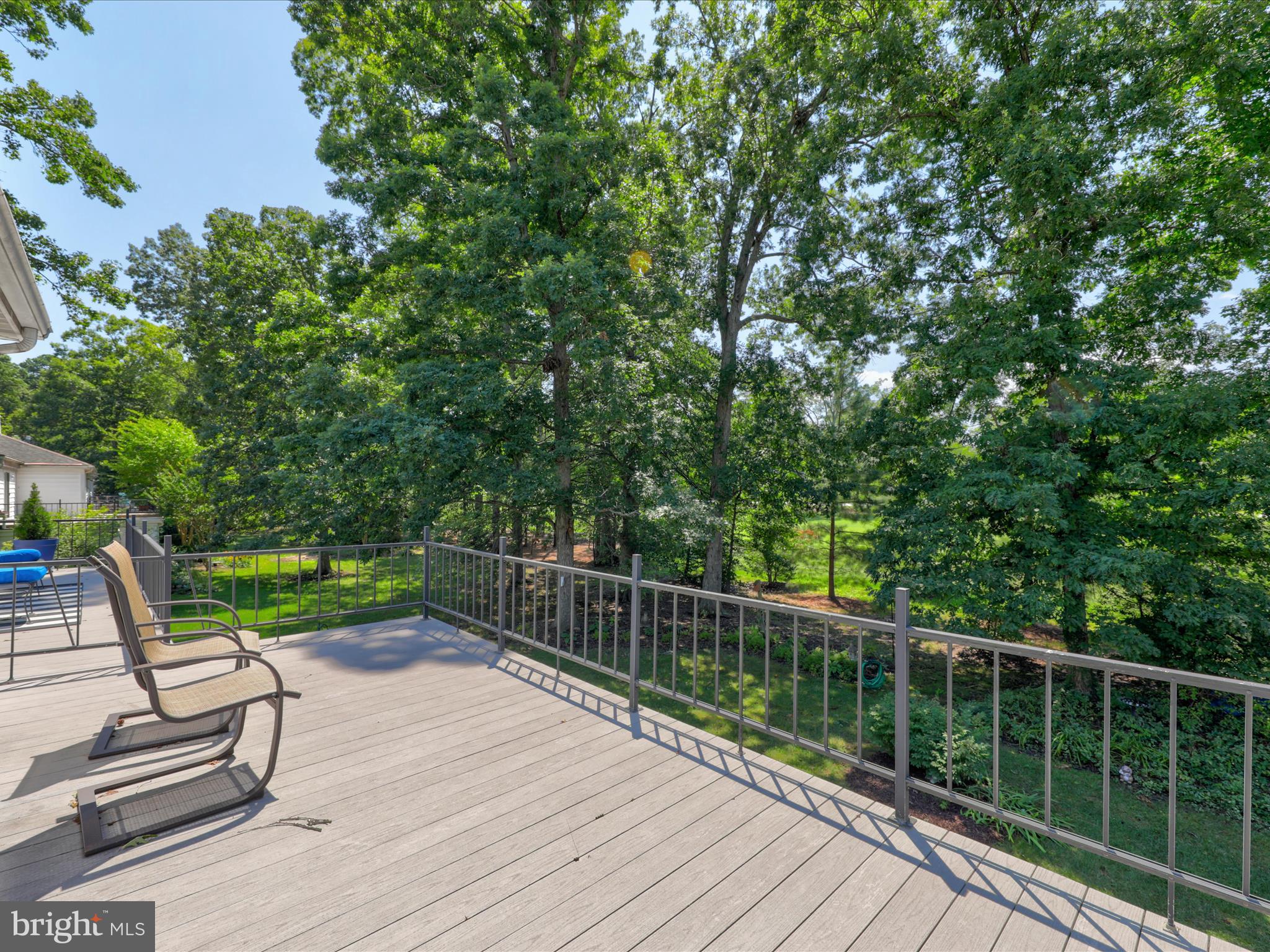 24345 Widgeon Place, Unit 29 St. Michaels, MD 21663 - Photo 35 of 38 a view of a deck with two chairs and a table