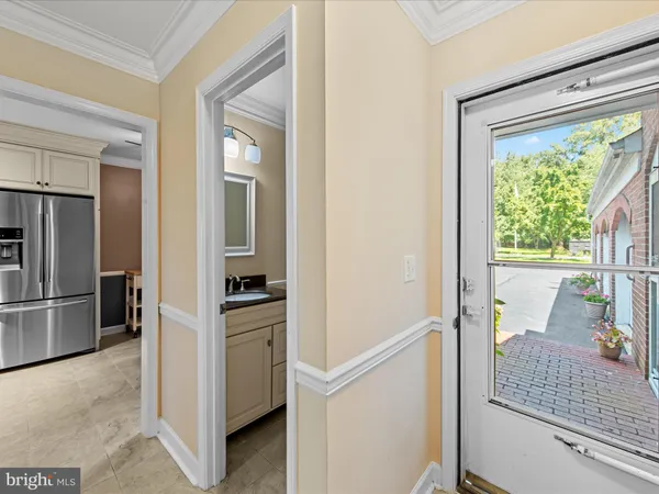 a kitchen with a refrigerator and a sink