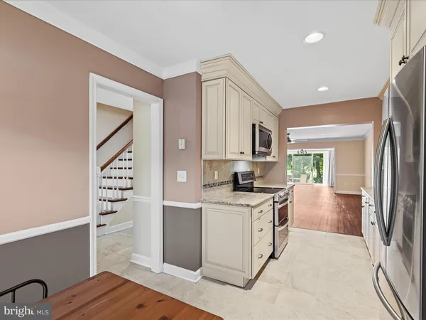a kitchen with cabinets and wooden floor