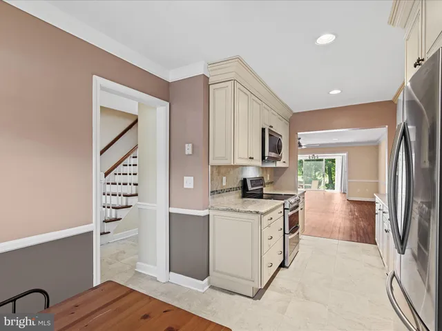 a kitchen with cabinets and wooden floor