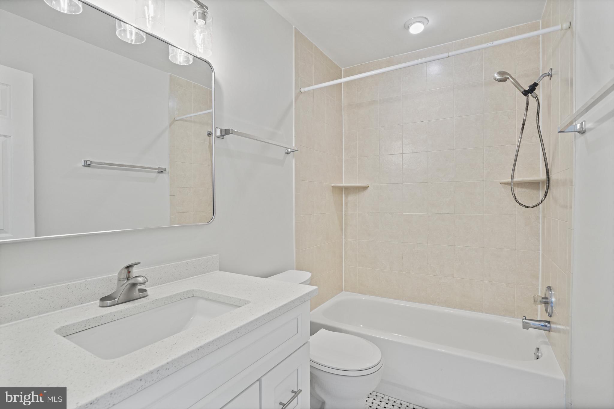 3823 9th Road South Arlington, VA 22204 - Photo 14 of 40 a bathroom with a granite countertop sink a toilet and shower