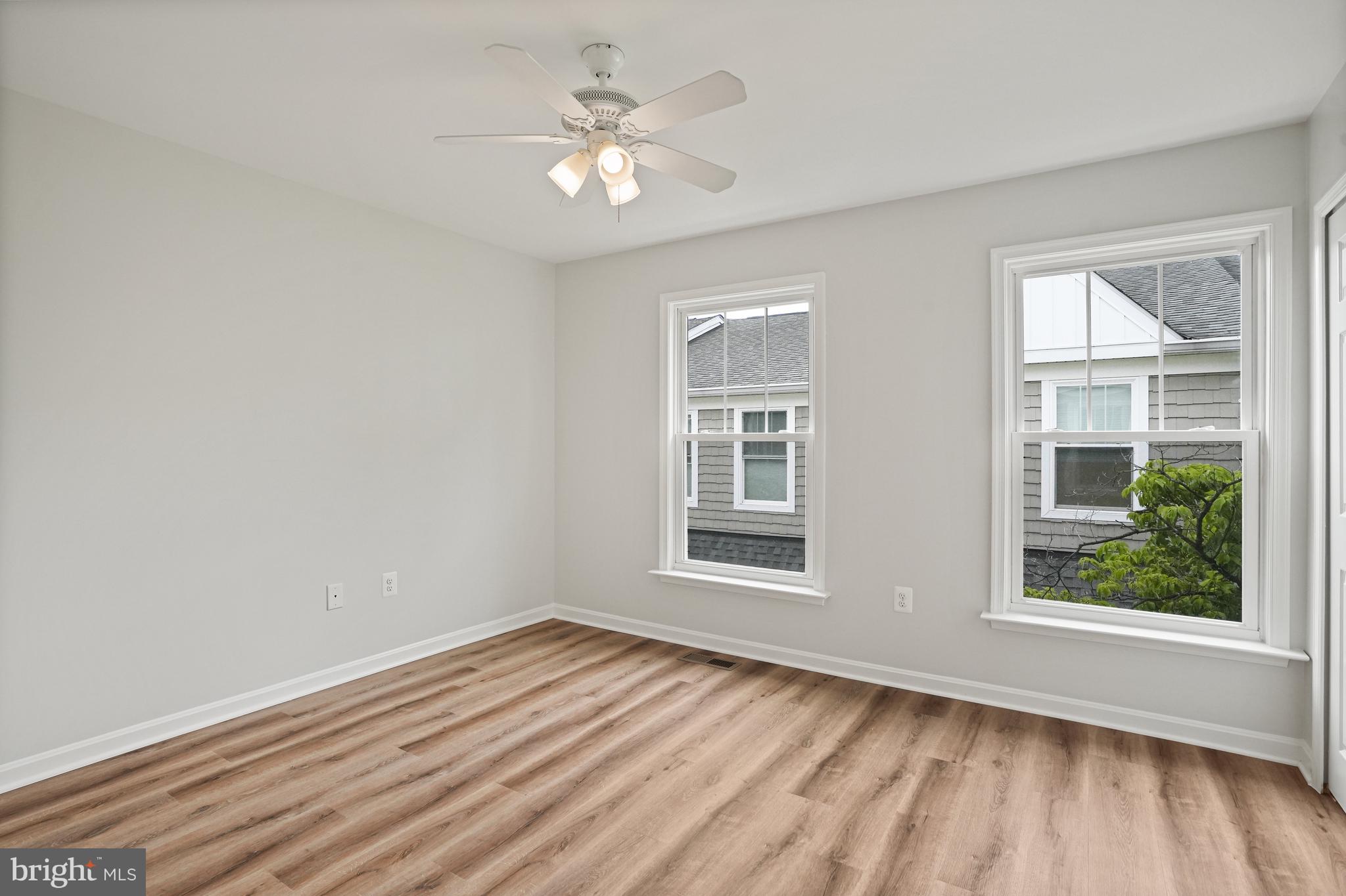 3823 9th Road South Arlington, VA 22204 - Photo 18 of 40 an empty room with wooden floor fan and windows
