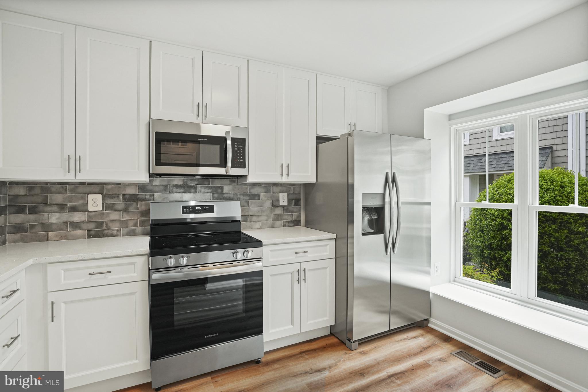 3823 9th Road South Arlington, VA 22204 - Photo 2 of 40 a kitchen with stainless steel appliances white cabinets and a stove top oven