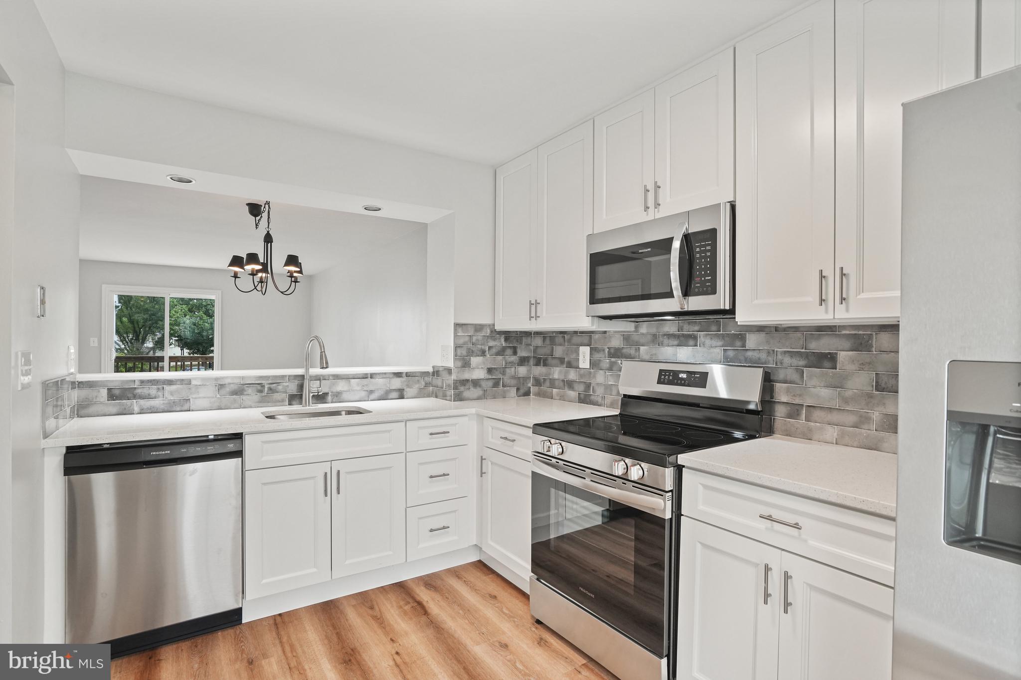 3823 9th Road South Arlington, VA 22204 - Photo 3 of 40 a kitchen with cabinets appliances a sink and a counter top space