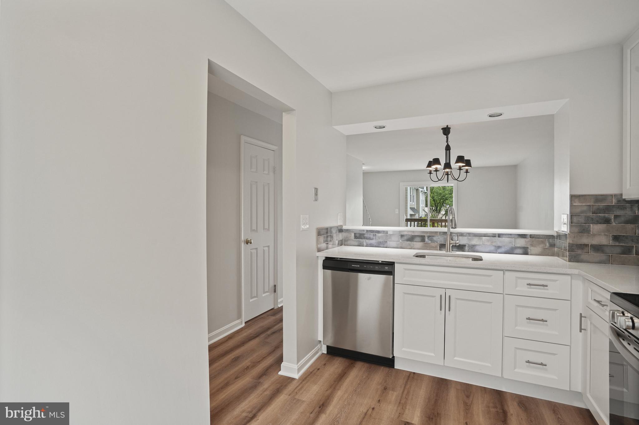 3823 9th Road South Arlington, VA 22204 - Photo 4 of 40 a kitchen with a sink cabinets and wooden floor