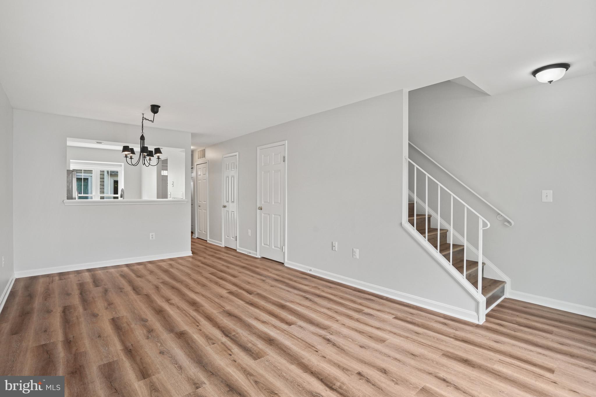 3823 9th Road South Arlington, VA 22204 - Photo 8 of 40 a view of an empty room with wooden floor and white walls
