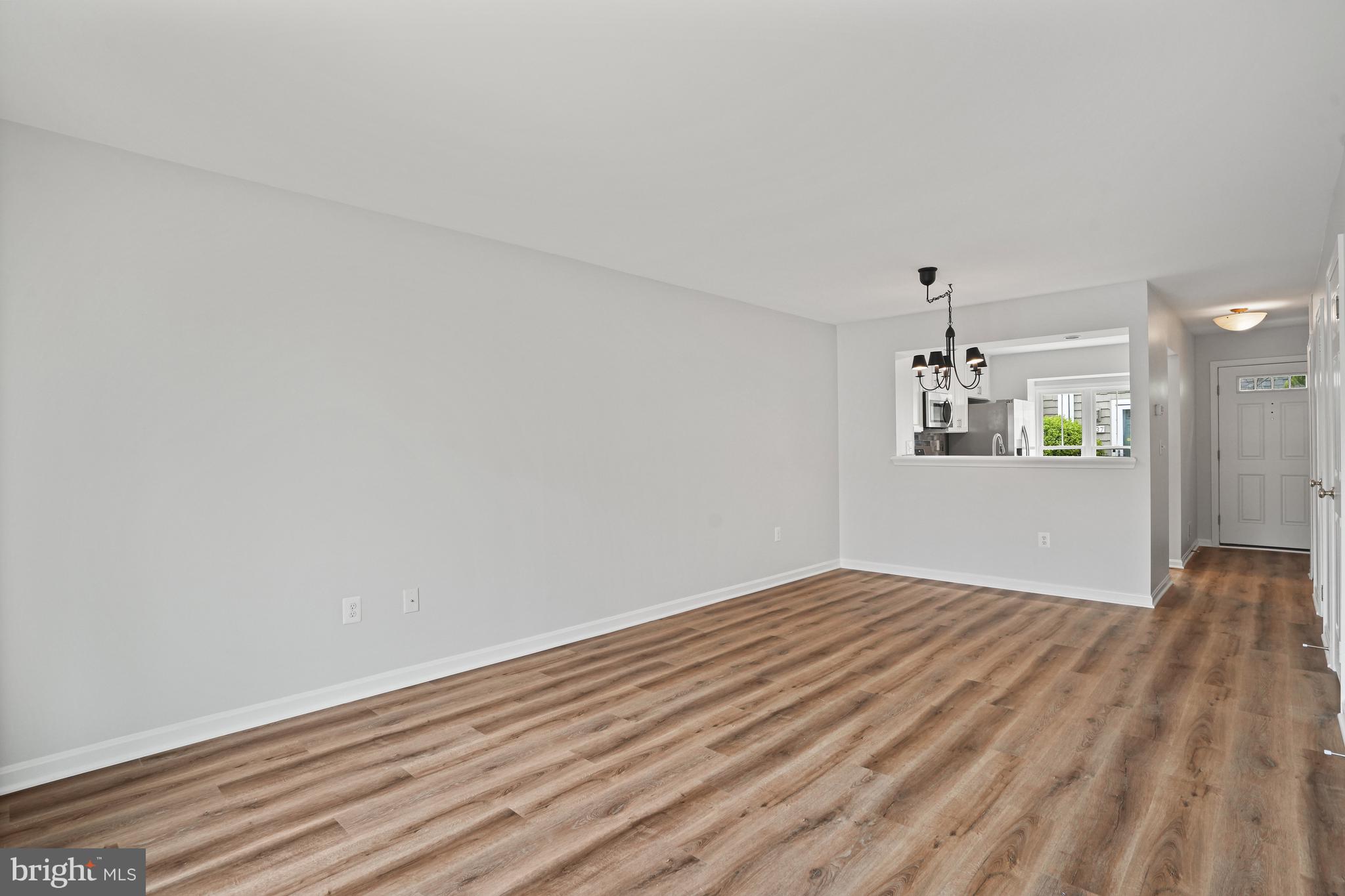 3823 9th Road South Arlington, VA 22204 - Photo 9 of 40 a view of empty room with wooden floor and fan