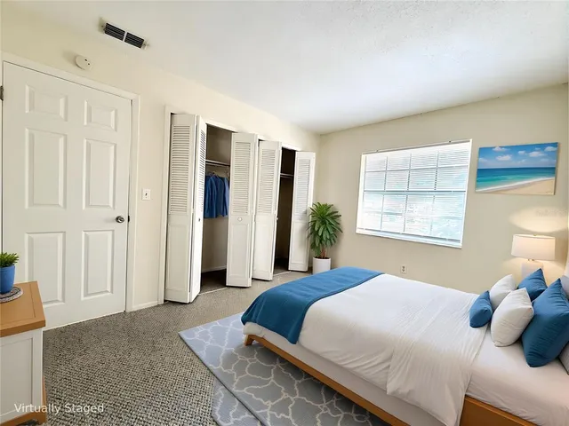 a bedroom with bed and window