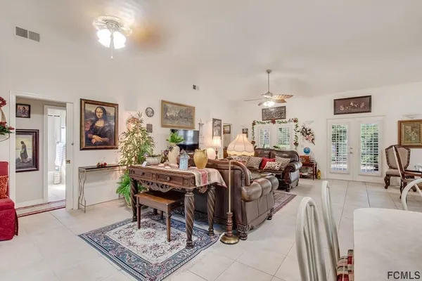 a living room with furniture a rug and a chandelier