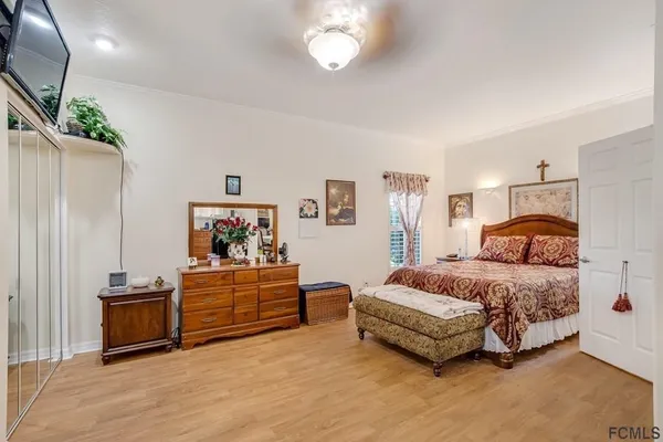 a spacious bedroom with a bed and a chandelier