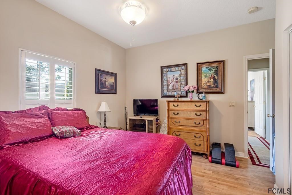 407 Domenico Circle St. Augustine, FL 32086 - Photo 26 of 33 a bedroom with a bed and a flat tv screen