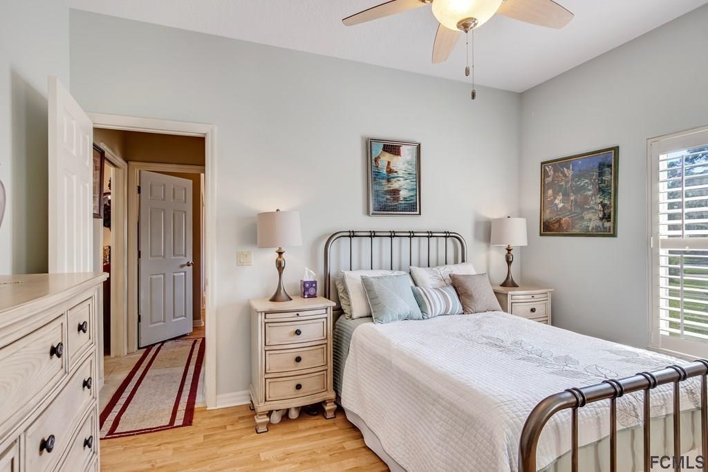 407 Domenico Circle St. Augustine, FL 32086 - Photo 29 of 33 a bedroom with a bed and a chandelier