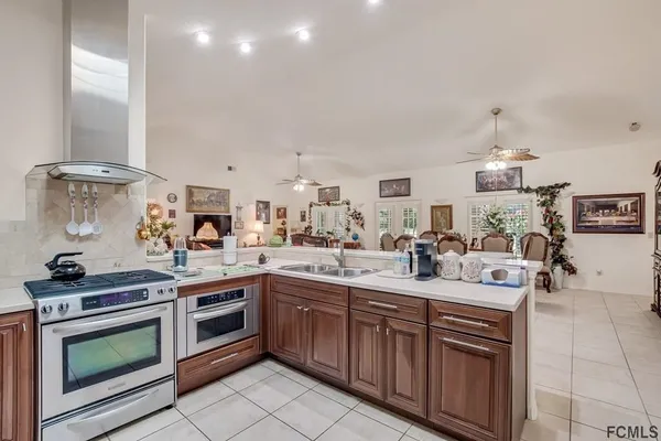 a kitchen with a sink stove and cabinets