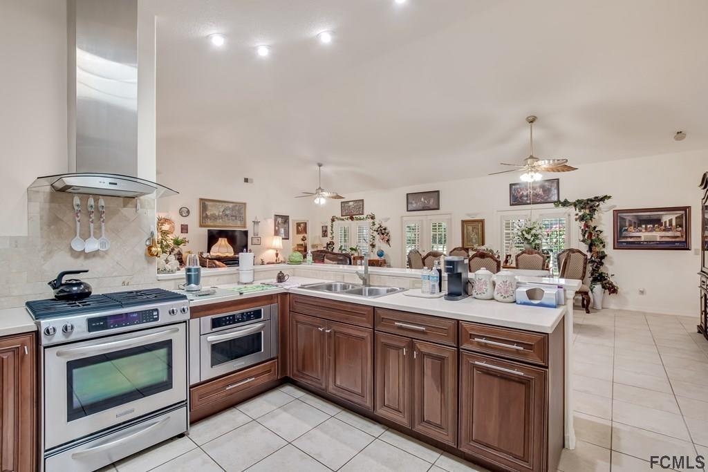 407 Domenico Circle St. Augustine, FL 32086 - Photo 6 of 33 a kitchen with a sink stove and cabinets