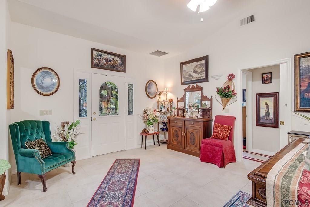 407 Domenico Circle St. Augustine, FL 32086 - Photo 8 of 33 a living room with furniture a rug and wall paintings