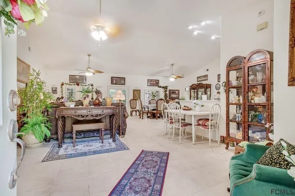 a living room with lots of furniture and a potted plant