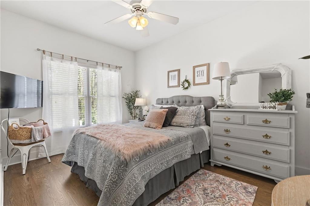 2964 Mill Grove Terrace Dacula, GA 30019 - Photo 11 of 86 a bedroom with a bed and a chandelier