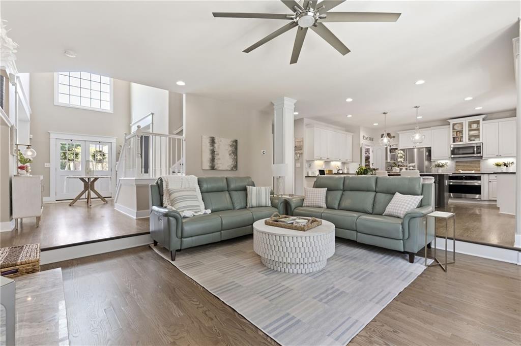 2964 Mill Grove Terrace Dacula, GA 30019 - Photo 12 of 86 a living room with furniture kitchen area and a wooden floor