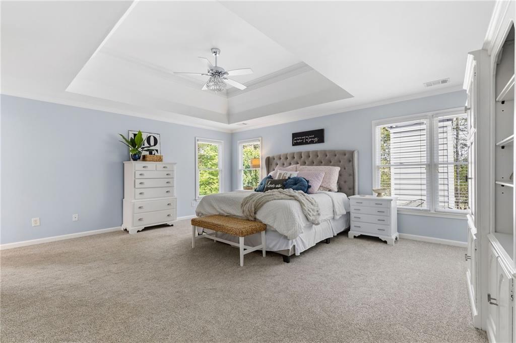 2964 Mill Grove Terrace Dacula, GA 30019 - Photo 28 of 86 a bedroom with a bed and a chandelier