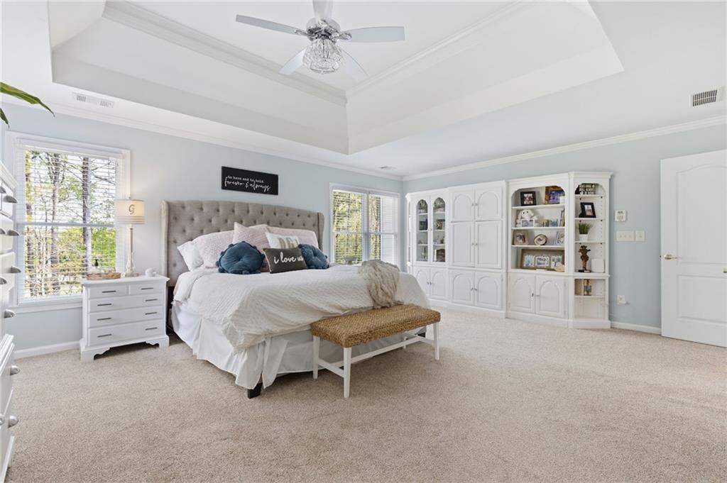 2964 Mill Grove Terrace Dacula, GA 30019 - Photo 29 of 86 a spacious bedroom with a bed a table and a large window