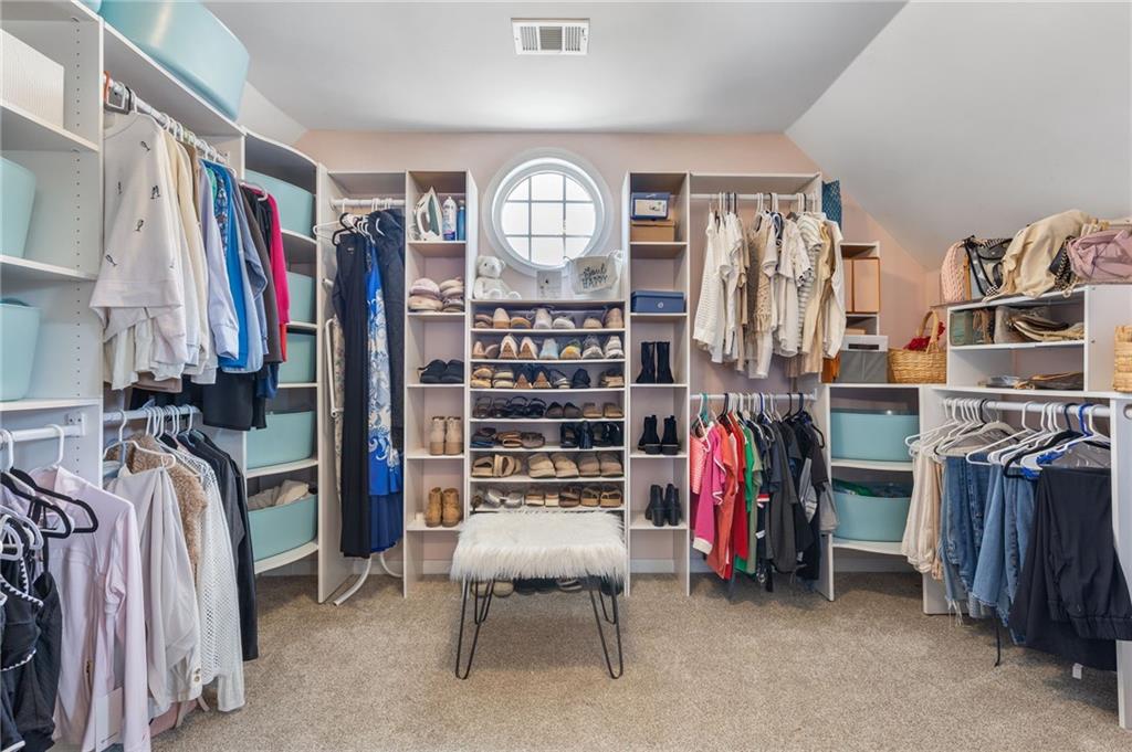 2964 Mill Grove Terrace Dacula, GA 30019 - Photo 34 of 86 a view of walk in closet with clothes and shoes