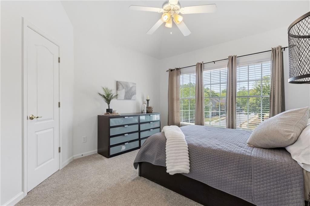 2964 Mill Grove Terrace Dacula, GA 30019 - Photo 38 of 86 a bedroom with a bed and a chandelier