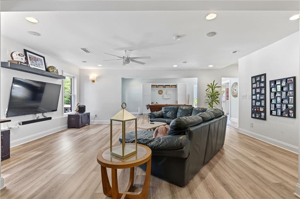 2964 Mill Grove Terrace Dacula, GA 30019 - Photo 47 of 86 a living room with furniture a flat screen tv and wooden floor
