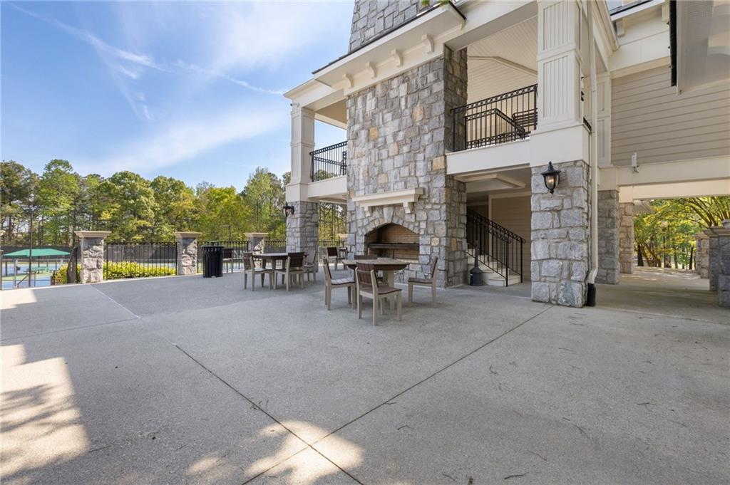 2964 Mill Grove Terrace Dacula, GA 30019 - Photo 83 of 86 a view of a patio with table and chairs and a fireplace