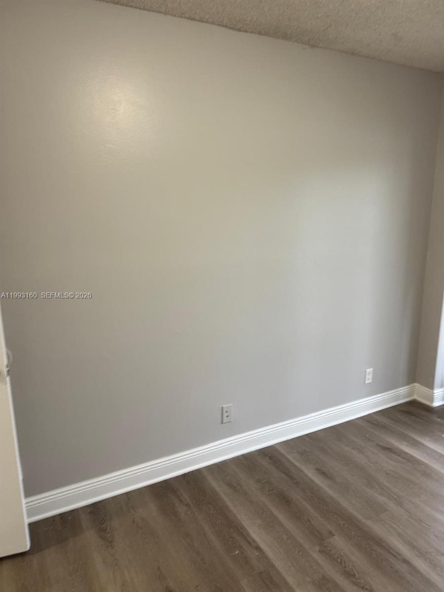 5780 Rock Island Road, Unit 362 Tamarac, FL 33319 - Photo 7 of 10 an empty room with wooden floor