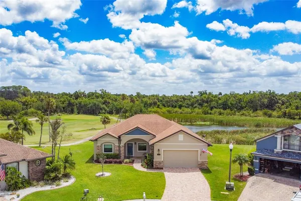a aerial view of a house with pool and a yard