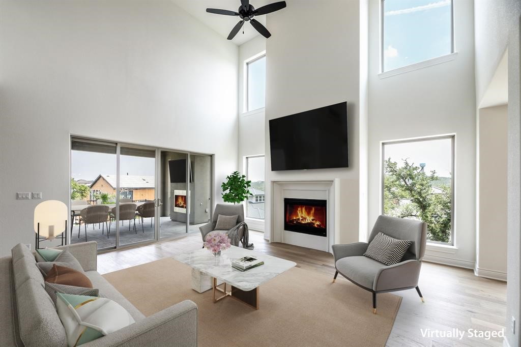 4801 Serene Hills Drive Austin, TX 78738 - Photo 1 of 1 a living room with furniture a fireplace and a flat screen tv