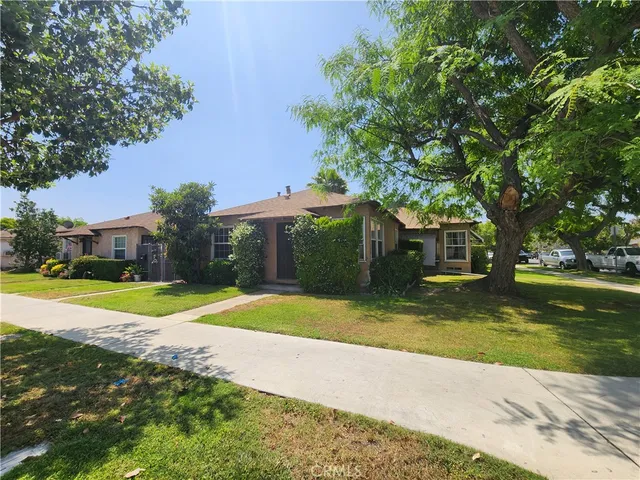 a view of a house with a yard and tree s