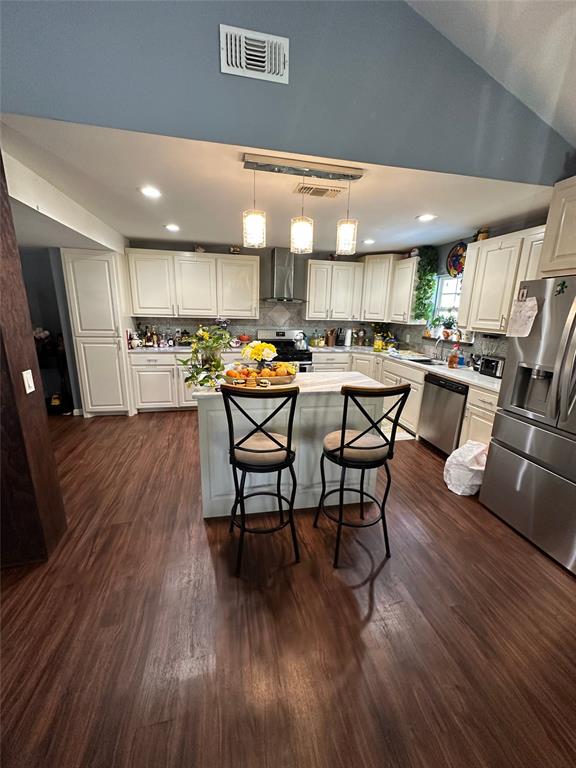 2839 Harts Bluff Road Mount Pleasant, TX 75455 - Photo 11 of 27 a kitchen with stainless steel appliances wooden floors and wooden cabinets