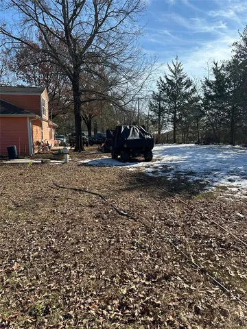 a view of a tree in front of a house