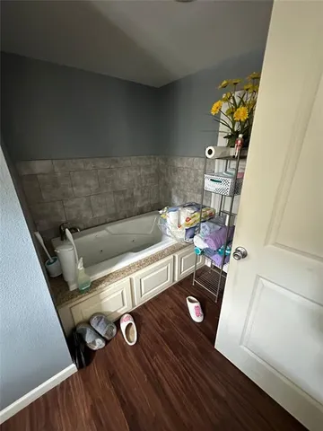 a view of sitting area in kitchen with stainless steel appliances wooden floor