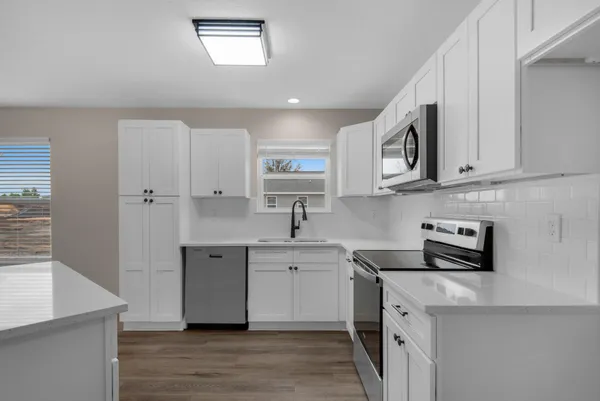 a kitchen with appliances cabinets and a sink