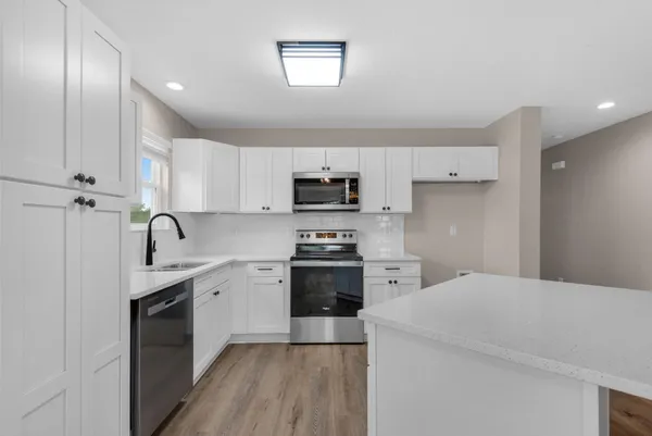 a kitchen with a sink stainless steel appliances and cabinets