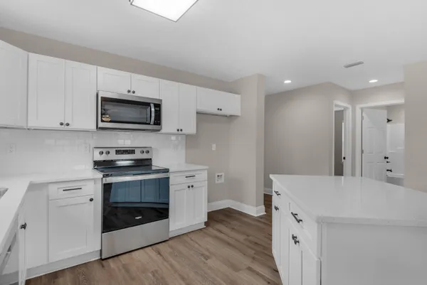 a kitchen with stainless steel appliances a stove microwave and refrigerator
