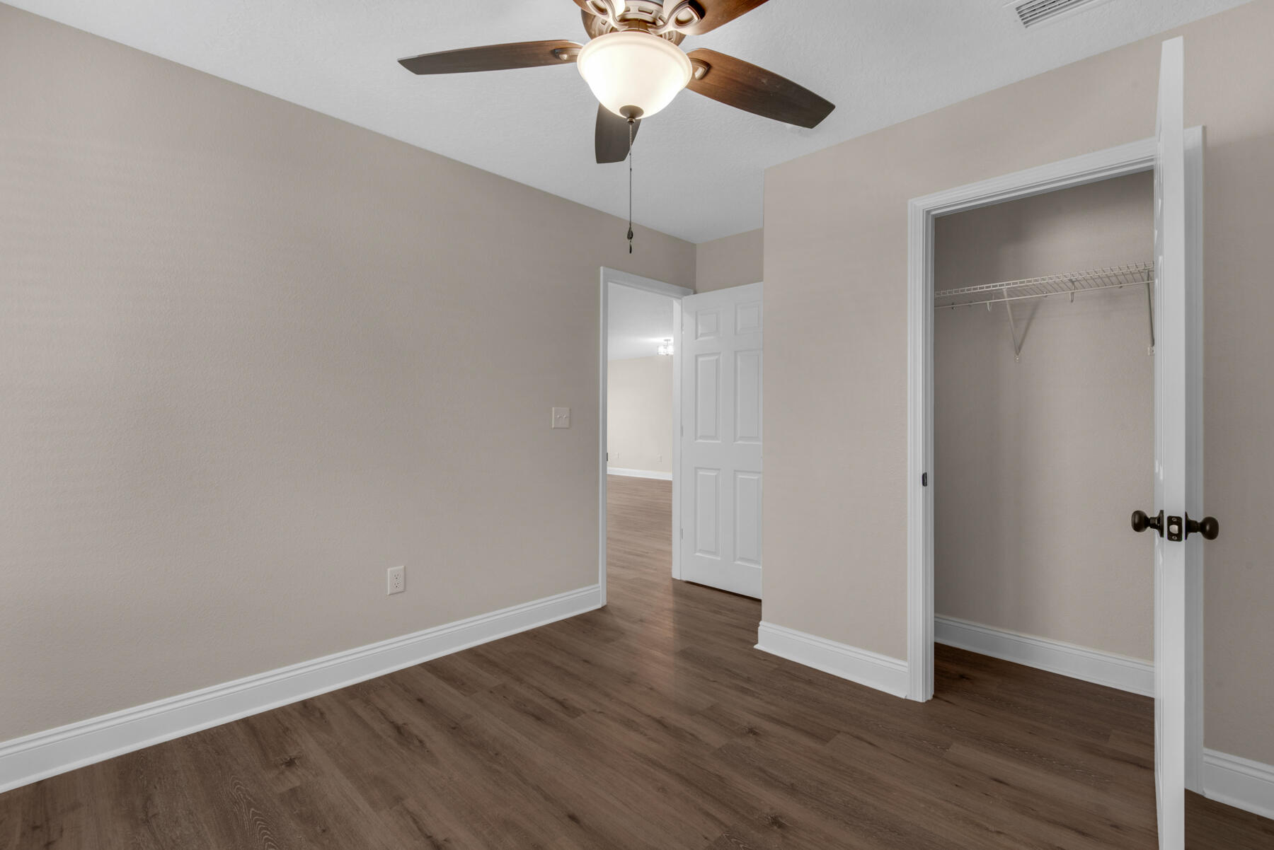 5438 Bayleaf Drive Crestview, FL 32539 - Photo 23 of 35 a view of an empty room with wooden floor