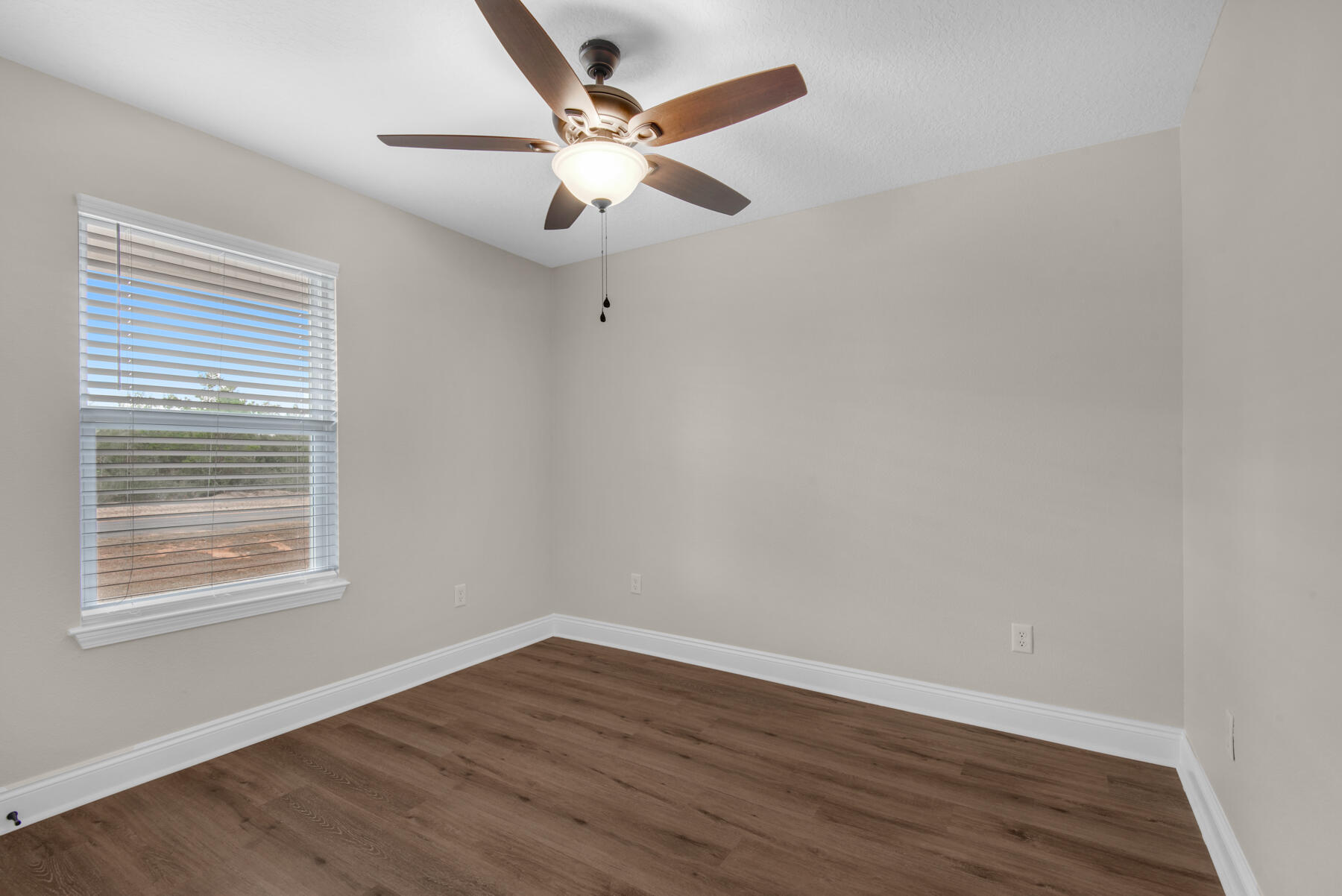 5438 Bayleaf Drive Crestview, FL 32539 - Photo 25 of 35 an empty room with wooden floor fan and windows