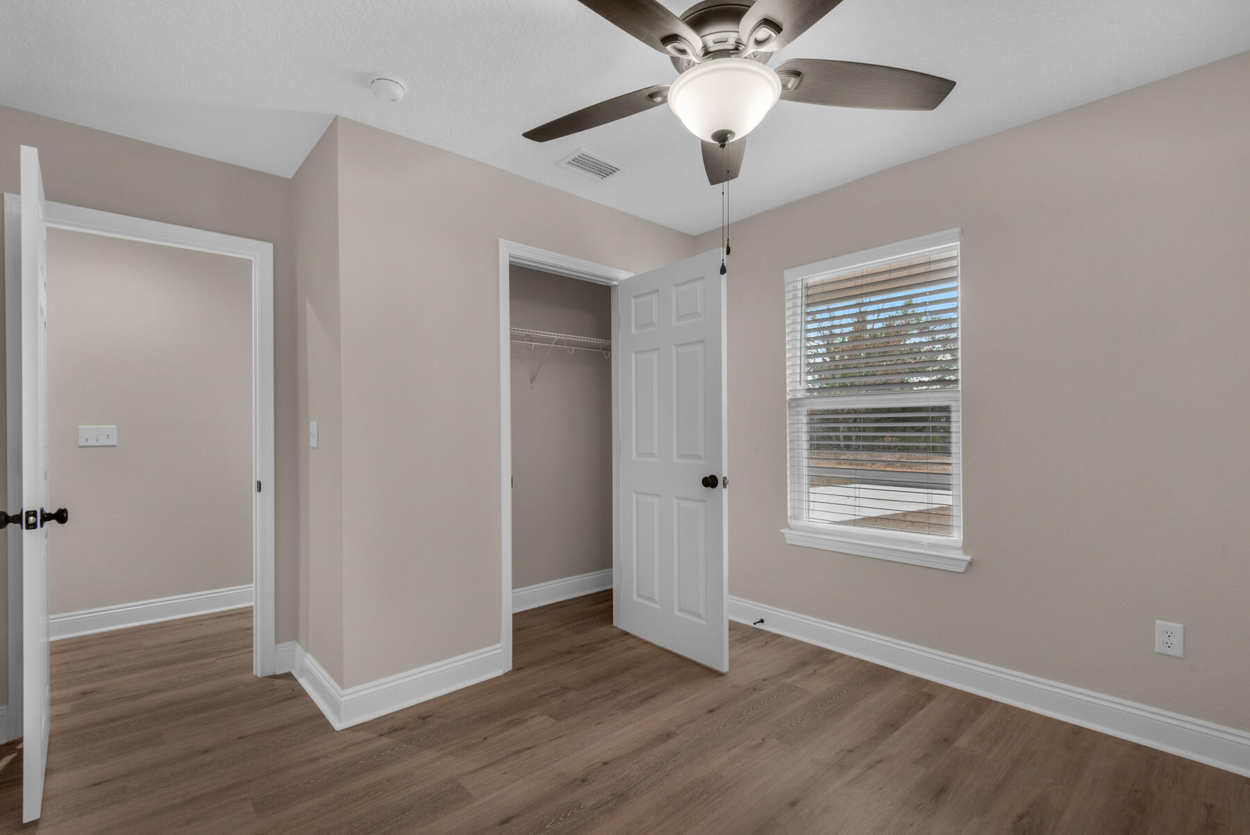 5438 Bayleaf Drive Crestview, FL 32539 - Photo 26 of 35 a view of an empty room with wooden floor and a window