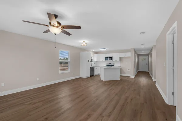 a view of a kitchen with wooden floor