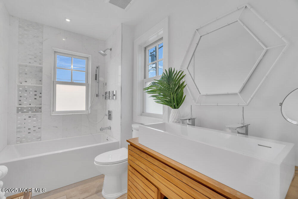 985 North Ocean Avenue Mantoloking, NJ 08738 - Photo 130 of 163 a bathroom with a sink a toilet a tub and shower