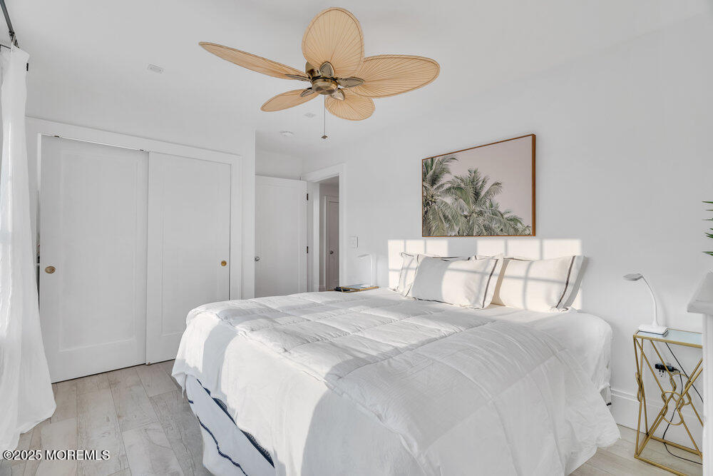 985 North Ocean Avenue Mantoloking, NJ 08738 - Photo 134 of 163 a bedroom with a large bed and a chandelier