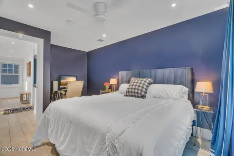 a front view of a house with a yard and lake view