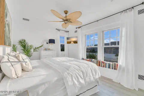 a living room with hard wood floors and a dresser