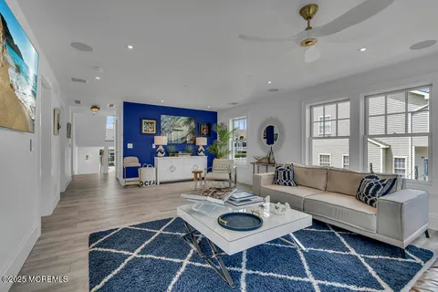 a living room with hard wood floors and a dresser