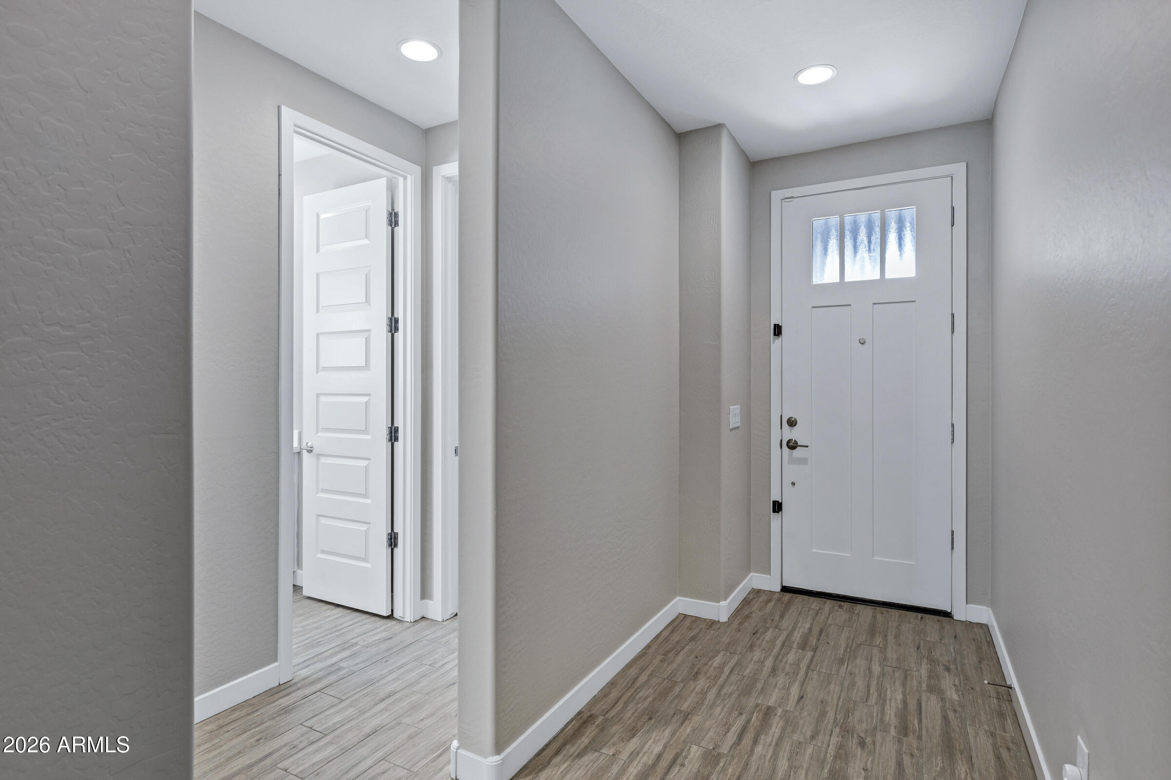 12243 East Sereno Road Gold Canyon, AZ 85118 - Photo 6 of 37 an empty room with wooden floor and windows