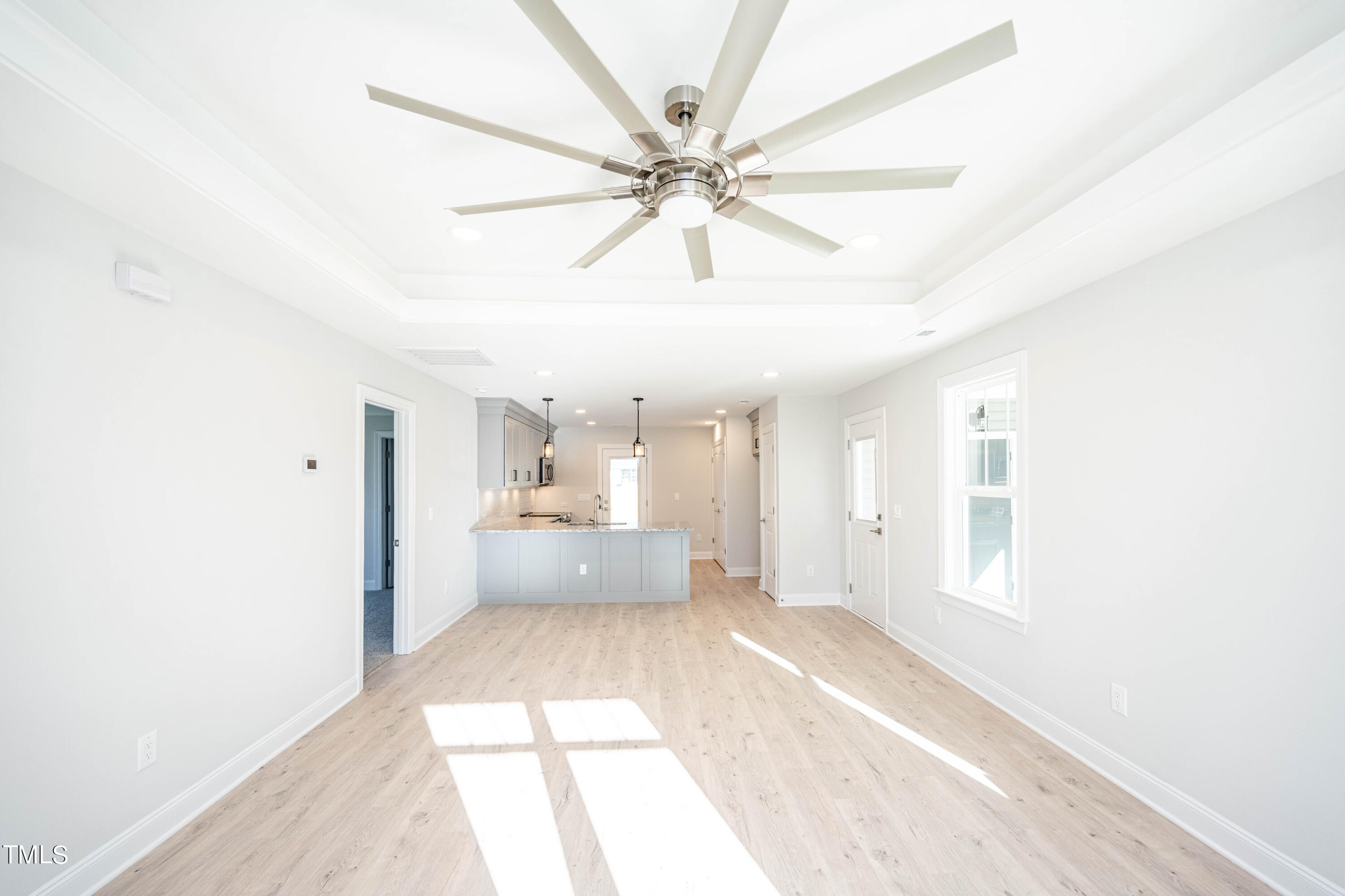 120 Jupiter Drive Dunn, NC 28334 - Photo 12 of 40 a view of a hallway to a bedroom with wooden floor and a ceiling fan