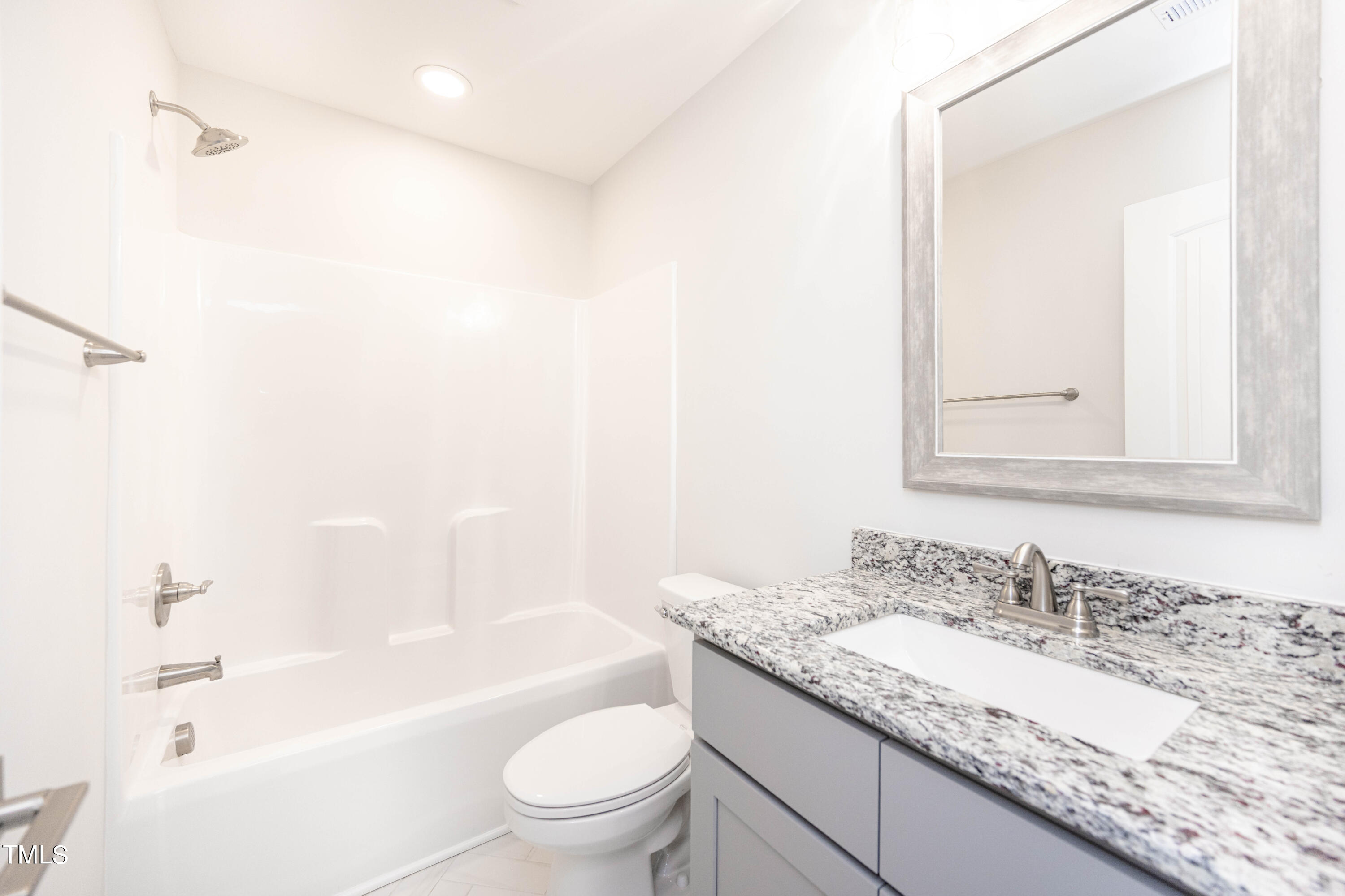 120 Jupiter Drive Dunn, NC 28334 - Photo 16 of 40 a bathroom with a granite countertop sink a toilet and shower